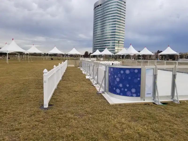 Amanzi synthetic ice rink installed outdoors with seating and a city backdrop